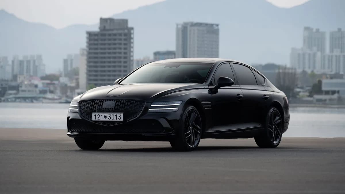 A sleek black luxury sedan against an urban city skyline — professional black-car service